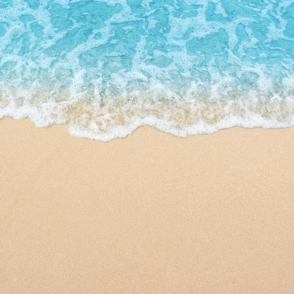 Beach and shore backdrop with soft sand and open sky